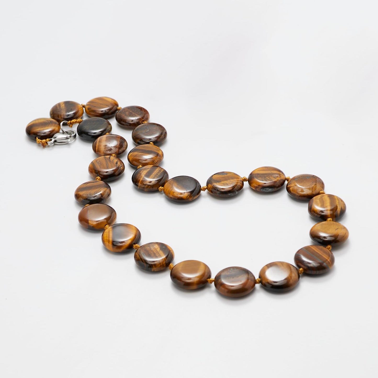 Round Disc Tiger's Eye Gemstone Necklace against a Light Grey background